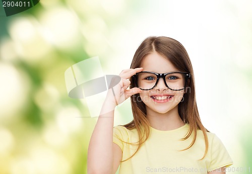 Image of smiling cute little girl in black eyeglasses