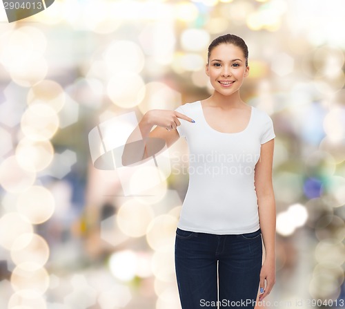 Image of smiling young woman in blank white t-shirt