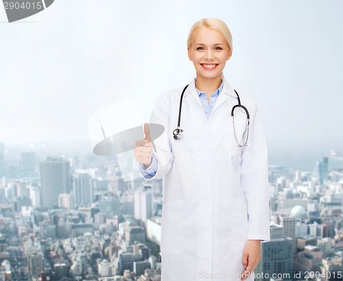 Image of smiling female doctor showing thumbs up