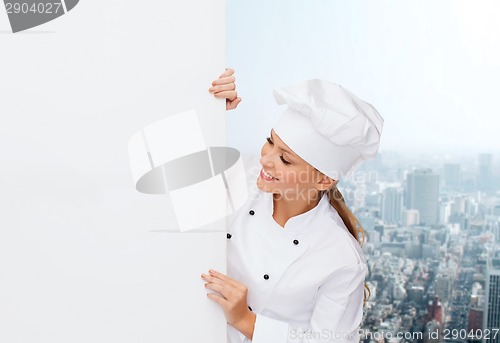 Image of smiling female chef with white blank board