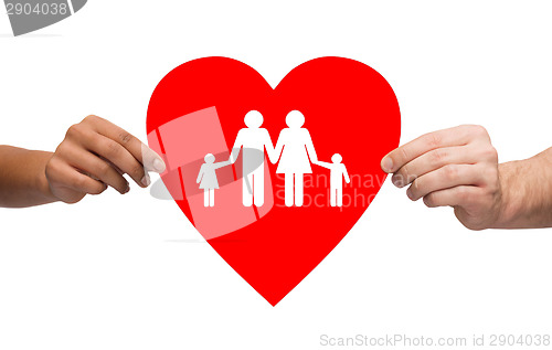 Image of couple hands holding red heart with family