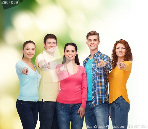 Image of group of smiling teenagers over green background