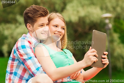 Image of smiling couple with tablet pc making selfie