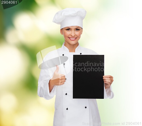 Image of smiling female chef with black blank paper