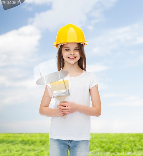 Image of smiling little girl in helmet with paint brush