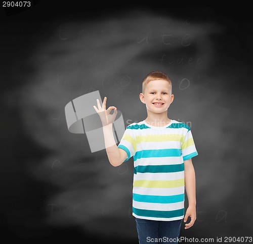 Image of little boy in casual clothes making ok gesture