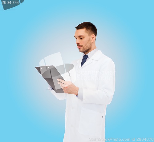 Image of serious male doctor with clipboard