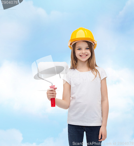 Image of smiling little girl in helmet with paint roller