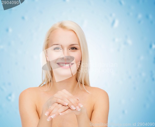 Image of face and hands of beautiful woman