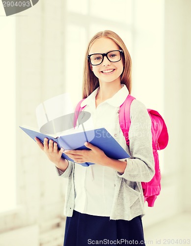 Image of girl reading book at school