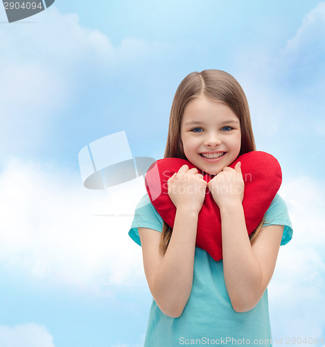 Image of smiling little girl with red heart