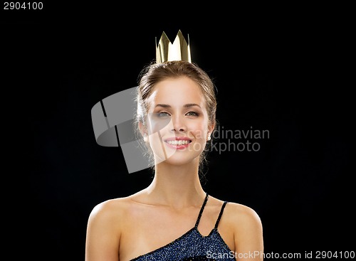 Image of smiling woman in evening dress wearing crown