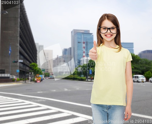 Image of smiling cute little girl in black eyeglasses