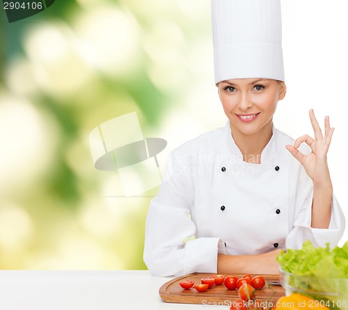 Image of female chef with vegetables showing ok sign