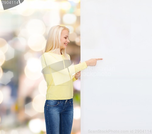 Image of smiling woman in sweater with blank white board