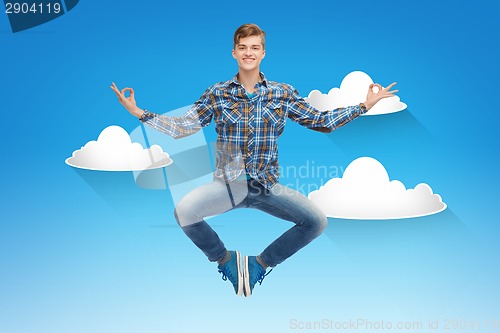 Image of smiling young man jumping in air