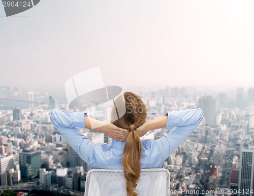 Image of businesswoman sitting on chair from back