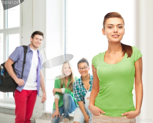 Image of smiling young woman in blank green t-shirt