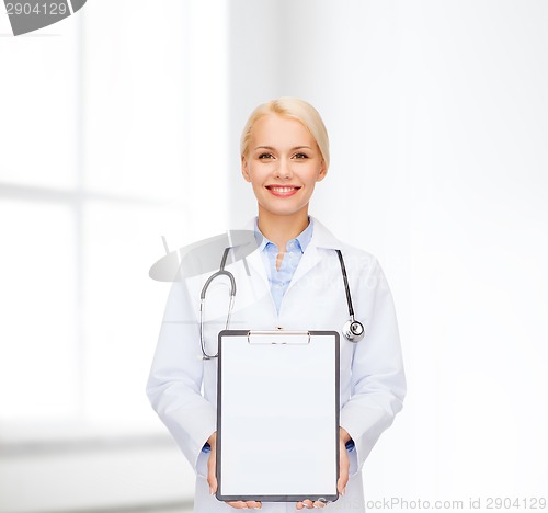 Image of smiling female doctor with clipboard