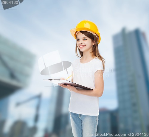 Image of smiling little girl in hardhat with clipboard