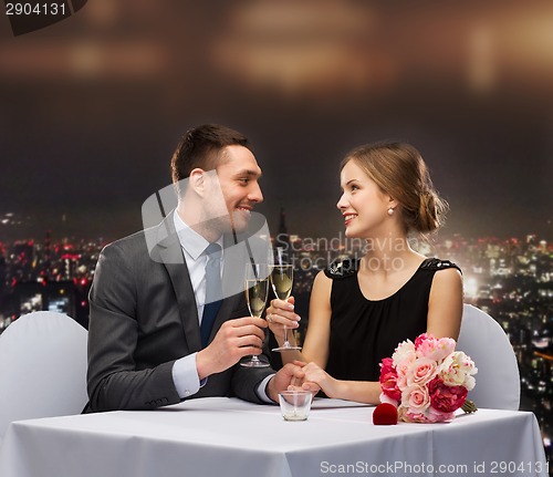 Image of couple with glasses of champagne at restaurant