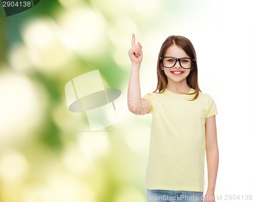 Image of smiling cute little girl in black eyeglasses