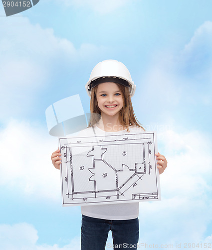 Image of smiling little girl in helmet showing blueprint