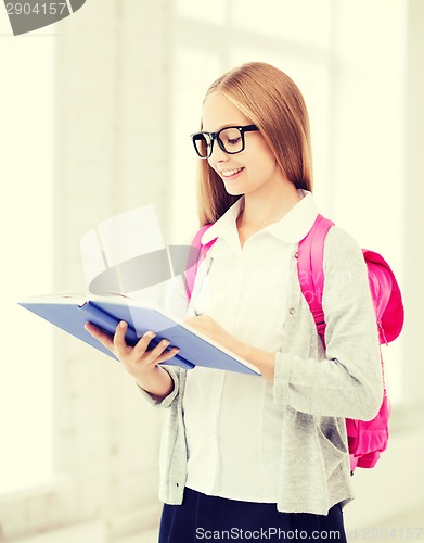 Image of girl reading book at school