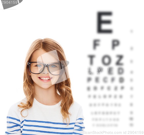 Image of smiling cute little girl with black eyeglasses