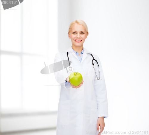 Image of smiling female doctor with green apple