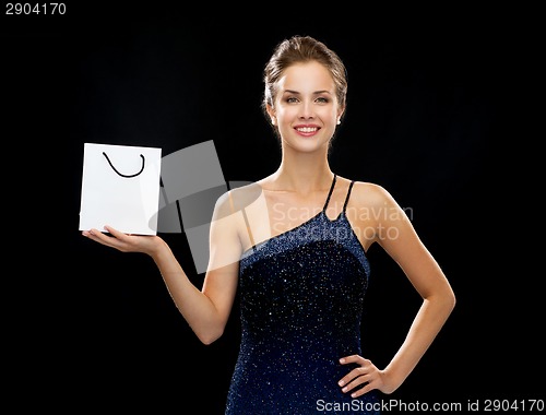 Image of smiling woman with white blank shopping bag