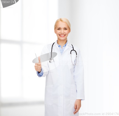 Image of smiling female doctor showing thumbs up