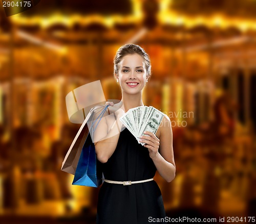 Image of smiling woman in dress with shopping bags