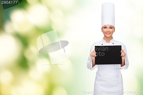 Image of smiling female chef with black blank paper