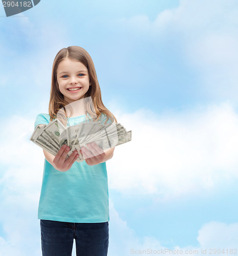 Image of smiling little girl giving dollar cash money