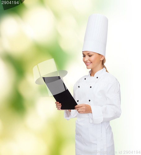 Image of smiling female chef with black blank paper