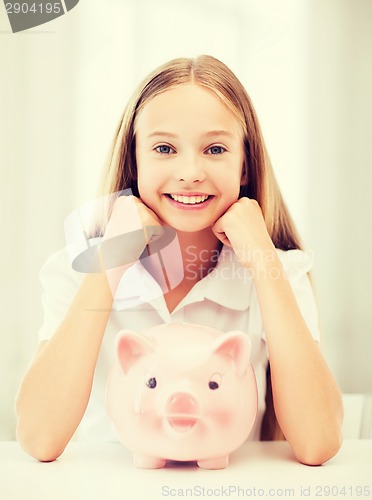 Image of child with piggy bank