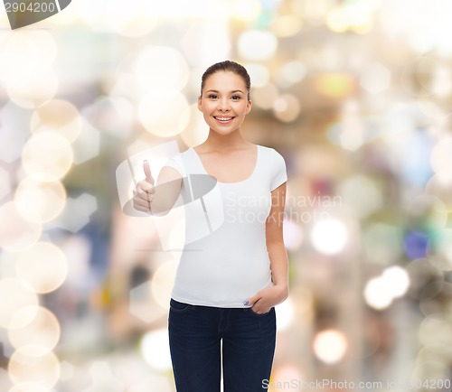 Image of smiling young woman in blank white t-shirt