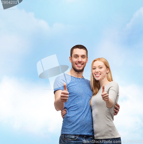 Image of smiling couple showing thumbs up