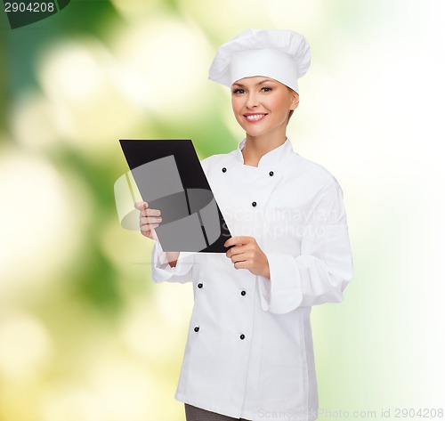 Image of smiling female chef with black blank paper