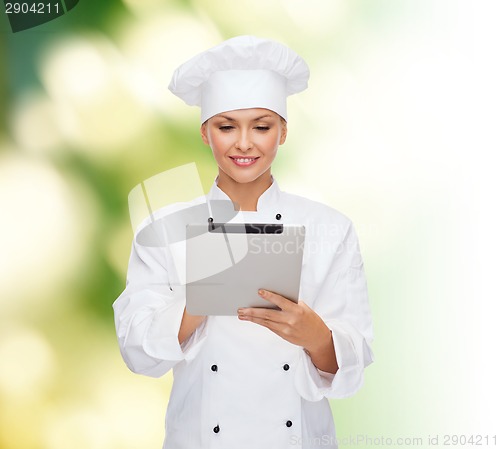 Image of smiling female chef with tablet pc computer