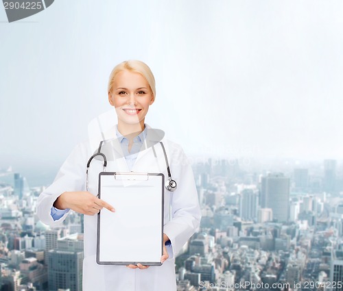 Image of smiling female doctor with clipboard