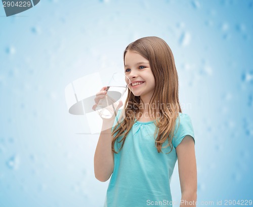 Image of smiling little girl with glass of water
