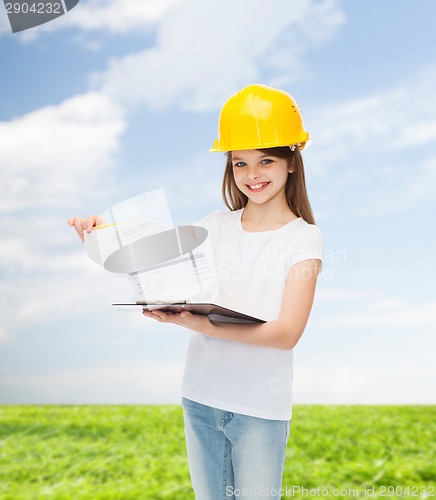 Image of smiling little girl in hardhat with clipboard