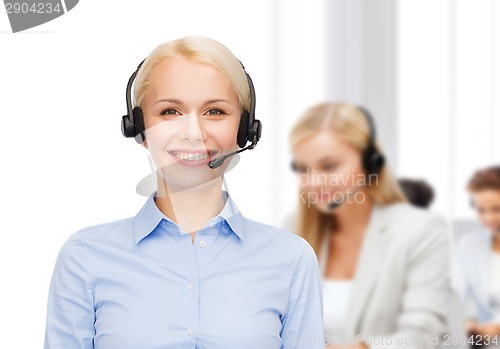 Image of friendly female helpline operator with headphones