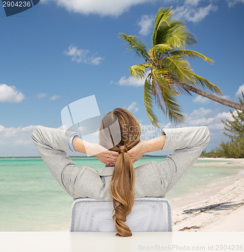 Image of businesswoman sitting on chair from back