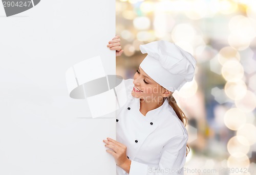 Image of smiling female chef with white blank board