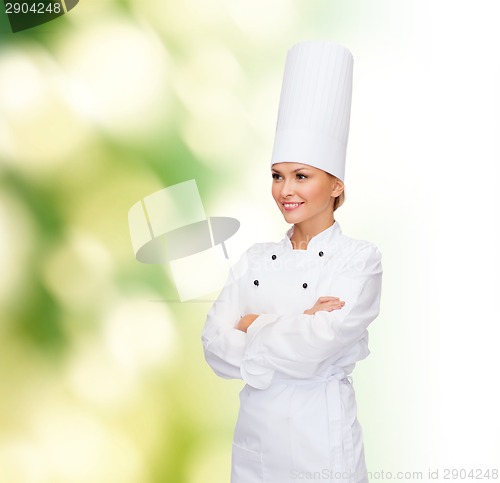 Image of smiling female chef with crossed arms