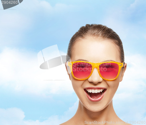 Image of happy teenage girl in pink sunglasses