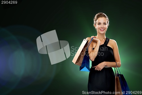 Image of smiling woman in dress with shopping bags